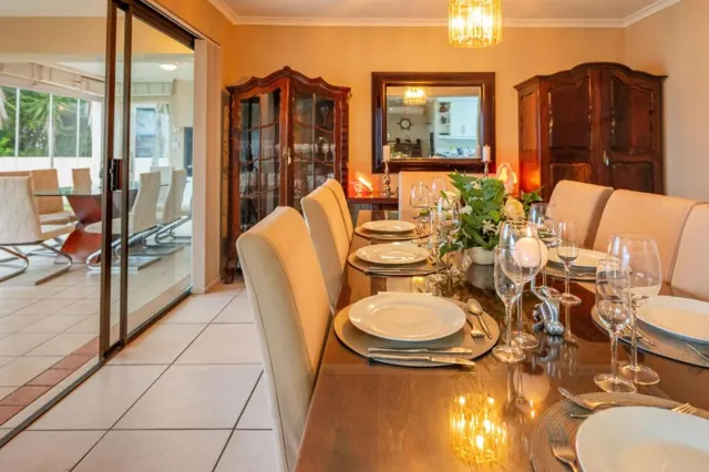 Dining table laid for dinner with wine glasses and candles