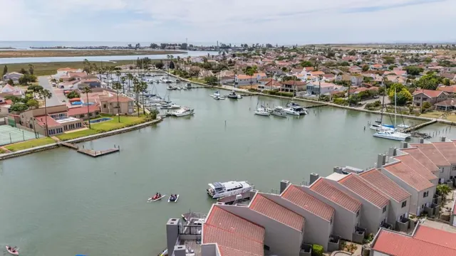 Aerial view over the marina basin, with boats moored along the waterfront