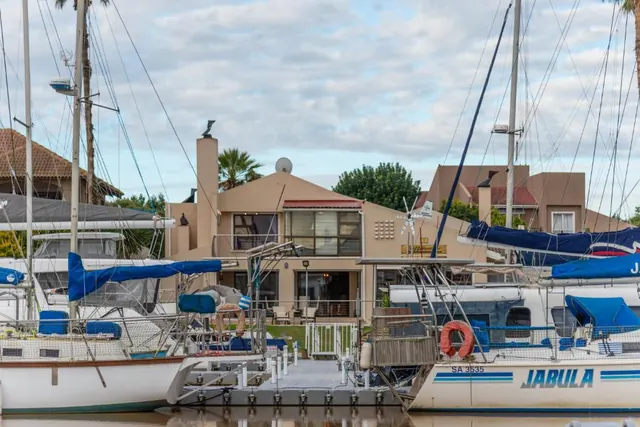 The Waterfront Villa seen across the marina between moored yachts